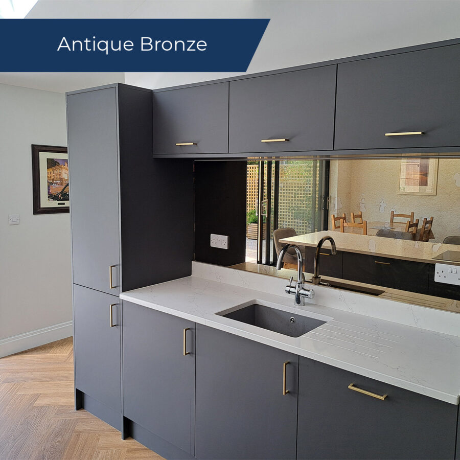 Antique bronze mirror splashback behind the sink in a modern kicthen.