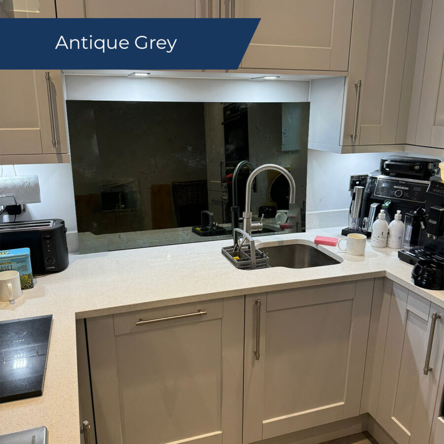 Antique grey mirror splashback behind the sink in a small kitchen