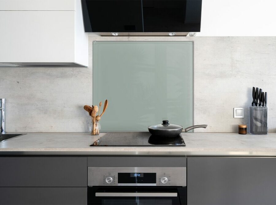 Jade Green Painted Kitchen Splashback on the wall behind a modern stove.