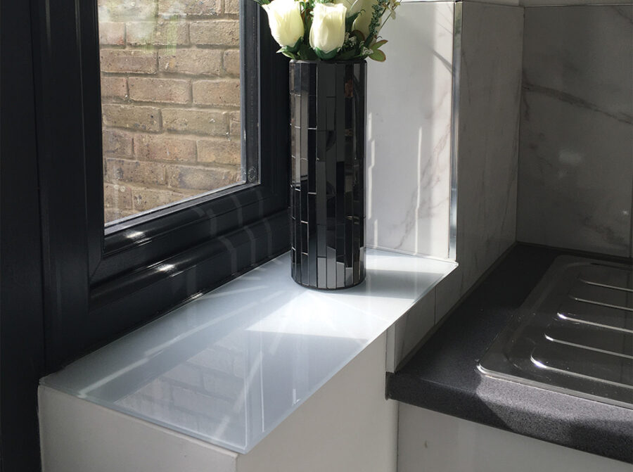 Light grey painted glass window sill in a kitchen