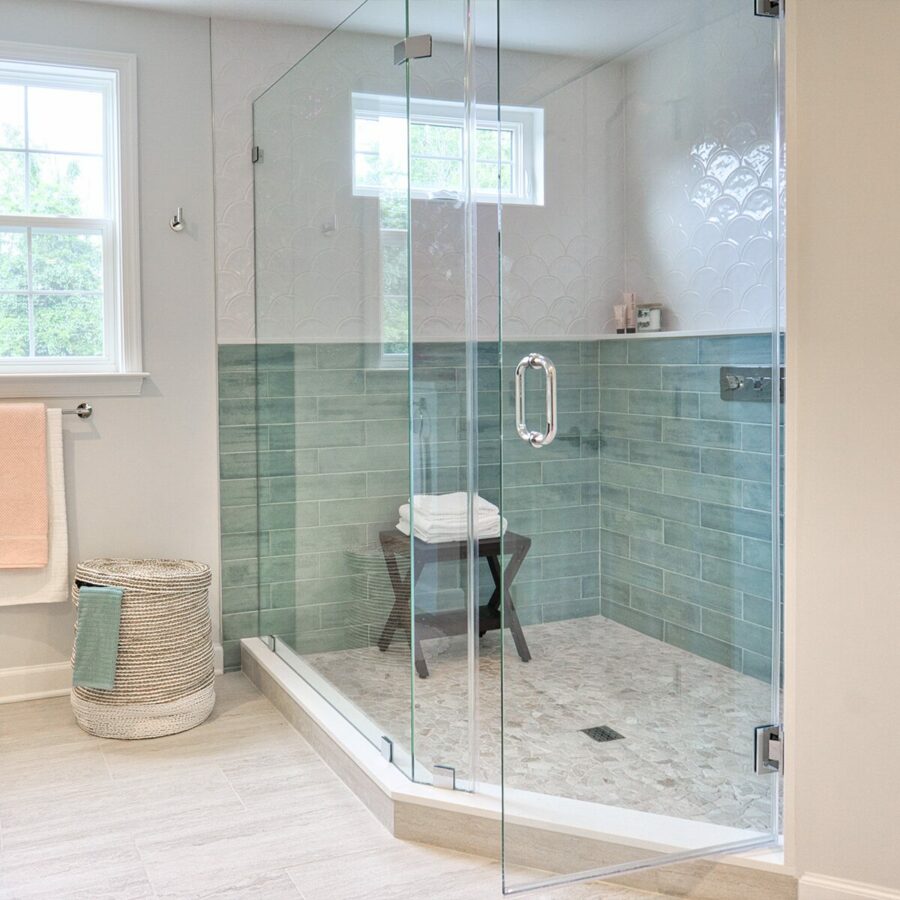 Toughened glass shower door attached to a wall with chrome glass toe wall hinges.