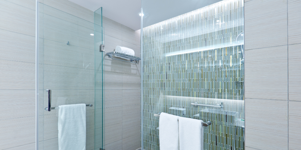 Frameless clear glass shower screens creating an ultra-modern shower enclosure.